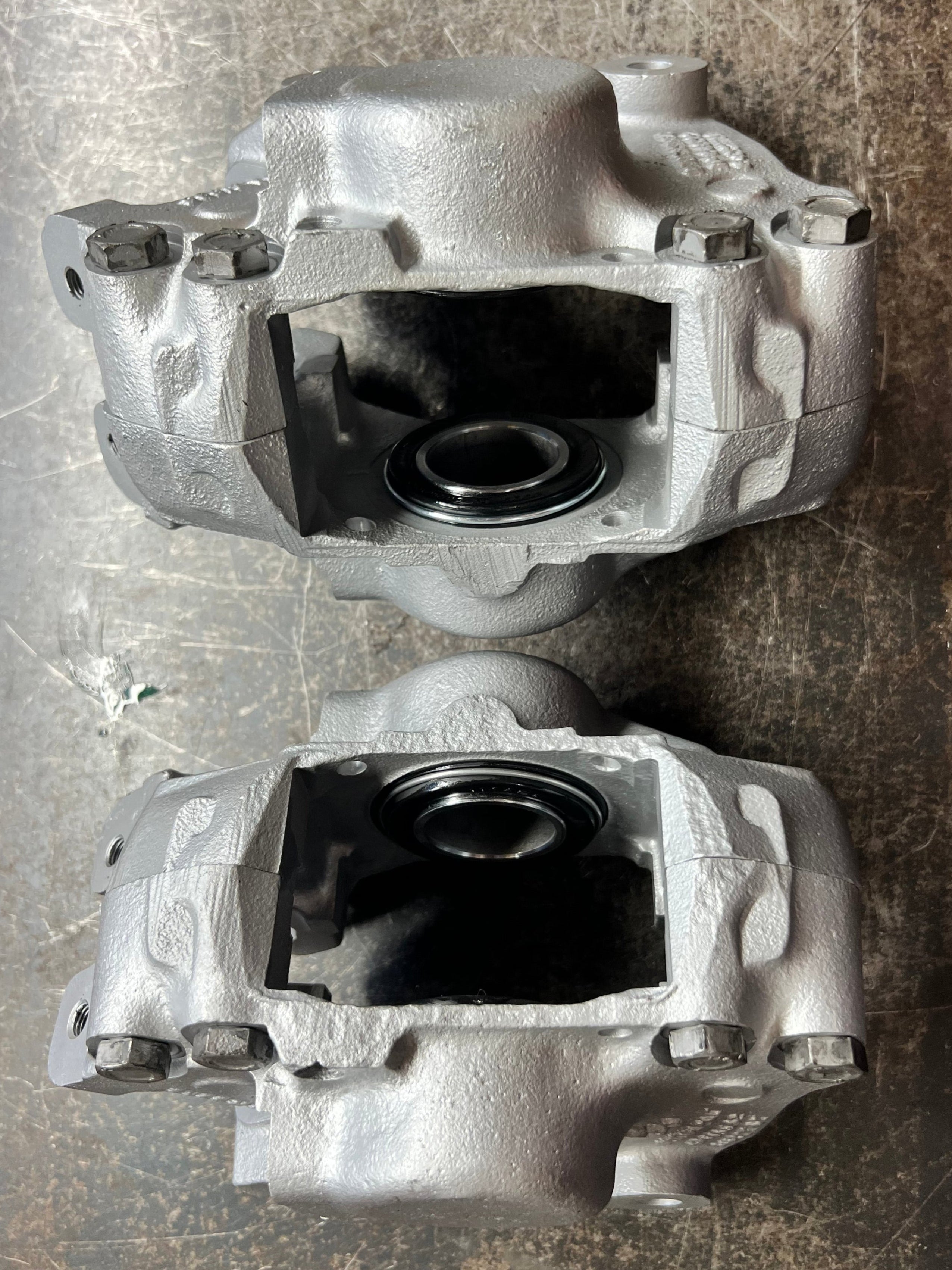 Two brake components on a bench surface